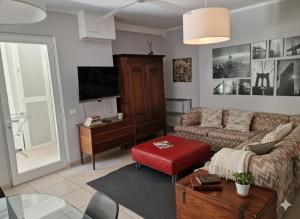 a living room with a couch and a tv at Residence Appartamenti Casa Vacanze Abbazia in Pesaro