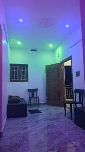 a room with a bed and a door and a table at MistyKera in Vattavada