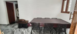 a dining room with a table and chairs at MistyKera in Vattavada