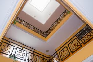 a coffered ceiling with a skylight and wrought iron railing at Hotel Avenida III in Villadangos del Páramo