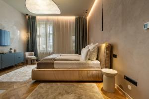 a bedroom with a large bed and a large window at The Rabbit Citadel in Sibiu