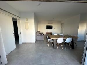 a dining room with a table and white chairs at Two Bedrooms Apartment with Private Balcony in Yukarı Lakatamya +22 photos