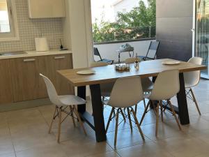 a wooden table and chairs in a kitchen at Two Bedrooms Apartment with Private Balcony in Yukarı Lakatamya