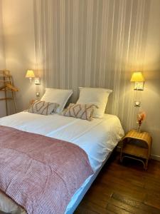 una camera da letto con un letto grande con lenzuola bianche di Horizon Troyen T11 a Troyes