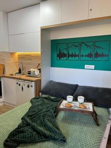a bedroom with a bed with a tray of food on it at Borovi30 in Divčibare +19 photos