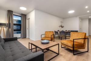 a living room with a couch and chairs and a table at EIR Apartments by Heimaleiga in Reykjavík +185 photos