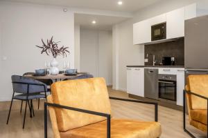 a kitchen and dining room with a table and chairs at EIR Apartments by Heimaleiga in Reykjavík