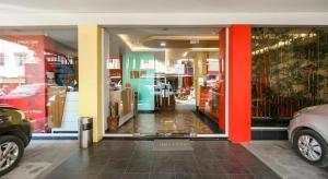 Una tienda con una puerta de cristal con coches. en Hotel JAV Front One, en Lahat