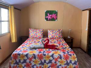 a bedroom with a bed with two red swans on it at Tropical Place in HUH