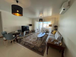 a living room with a couch and a table at Top floor Marina Duplex in Vila Franca do Campo