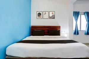 En eller flere senge i et værelse på Hotel O by OYO Ranchi Retreat