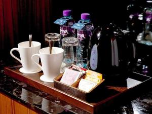 a tray with two coffee cups and bottles of water at Hotel COZi·Wetland in Hong Kong +37 photos