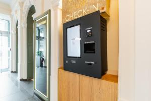 a check in kiosk in a building with a window at FortyPlusOne Hotel Vienna in Vienna +49 photos