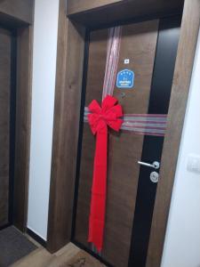 a door with a red bow on it at Borovi30 in Divčibare