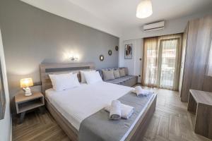 a bedroom with a large bed with towels on it at Dream Studios in Stavros