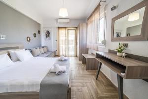 a bedroom with a large bed and a desk at Dream Studios in Stavros