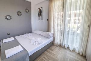 a small bedroom with a bed and a window at Dream Studios in Stavros