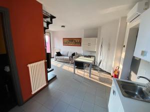 a kitchen and living room with a couch and a table at Residence Le Volte Apartments in Parma