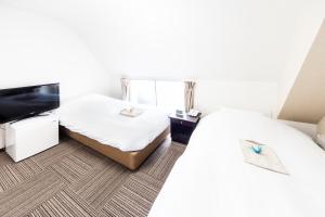 Postel nebo postele na pokoji v ubytování Best Hotel