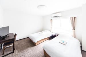 Postel nebo postele na pokoji v ubytování Best Hotel