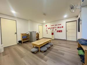 小竹林民宿 bamboo homestay 仙本那semporna 独栋房源 华语交流 步行码头10分钟 步行海鲜市场5分钟 في سيمبورنا: غرفة بها طاولة وغرفة بها كتابة على الحائط