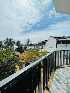 a balcony with a view of the ocean at Dondra OceanLight Villa in Gandara East