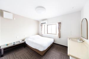 Postel nebo postele na pokoji v ubytování Best Hotel