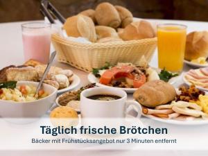 a table topped with plates of food and drinks at Heringsdorf, Ferienwohnung Hanni in Heringsdorf