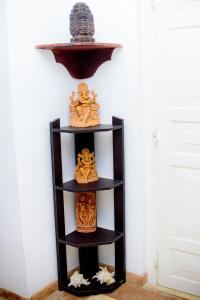 a shelf with many different types of objects on it at The Cozy Villa in Ambalangoda