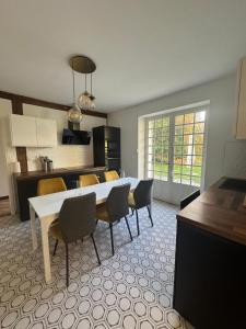 a kitchen and dining room with a table and chairs at Domaine de Chevillons in Chevillon-sur-Huillard
