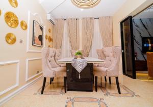 a dining room with a table and chairs at Pkeys in Lekki