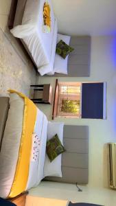 een kamer met een bed met kussens en een raam bij Homegate Marina Waterview Apartment in Araromi