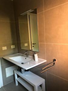 a bathroom with a sink and a mirror at Appartamento Stintino in Cuile Pazzoni