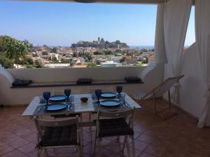 Un comedor con mesa y sillas y una gran ventana. en La Nacatola, en Lipari