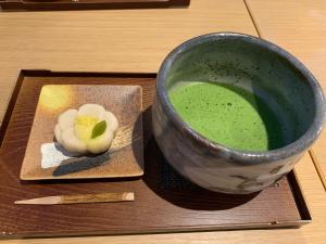 a bowl of green liquid next to a plate with a drink at Stay at matcha fields in Wazuka