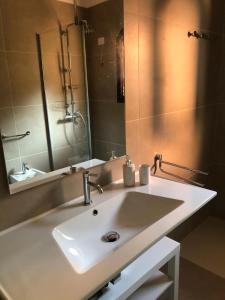 a bathroom with a sink and a mirror at Appartamento Stintino in Cuile Pazzoni +13 photos