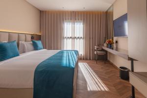 a hotel room with a large bed and a window at Citadines Almaz Aparthotel Casablanca in Casablanca
