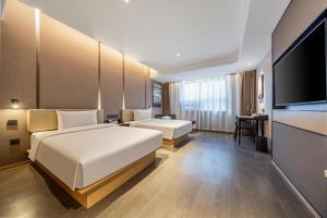 Una cama o camas en una habitación de Atour X Hotel Zaozhuang High-Railway Station