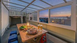 a table with food and drinks on a balcony at Donghae Hill Stay Pension in Donghae