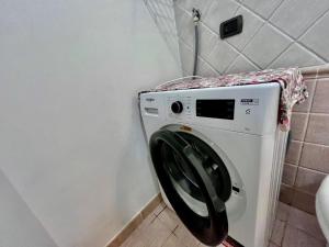 a washing machine in a bathroom with a towel at Casa Ariel - Elba Affitti in Rio nellʼElba