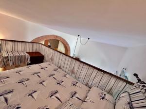 a large bed in a room with at Casa Ariel - Elba Affitti in Rio nellʼElba +18 photos