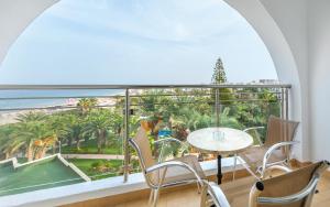 a balcony with a table and chairs and a view of the ocean at Hotel Marhaba Beach in Sousse +37 photos