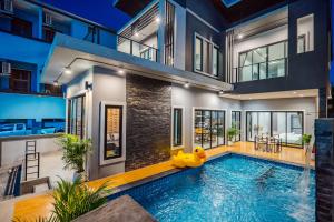 a pool in a house with a yellow duck in the middle at Lom-Talay poolvilla huahin in Hua Hin