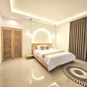 Un dormitorio con una cama grande y una ventana grande. en 3 Bedroom Private Pool Villa in Mengwi Kapal, en Kapal