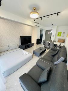 a bedroom with a bed and a couch and a tv at Agile TRX Luxury suite Bukit bintang in Kuala Lumpur +128 photos