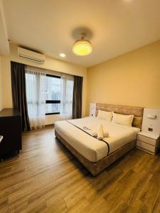 a bedroom with a large bed and a large window at Agile TRX Luxury suite Bukit bintang in Kuala Lumpur