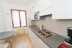 a kitchen with a sink and a stove top oven at Casa Luisella in Pieve Di Ledro