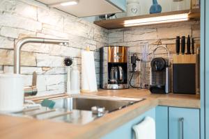 a kitchen with a sink and a counter top at NordseeResort Tossens - Seaside Corner in Tossenserdeich +28 photos