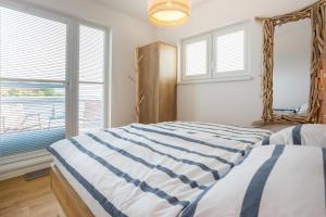 a bedroom with two beds and a window at NordseeResort Tossens - Seaside Corner in Tossenserdeich