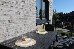 una mesa de madera con dos copas de vino en Küste33-15 - Strandnest, en Tossenserdeich